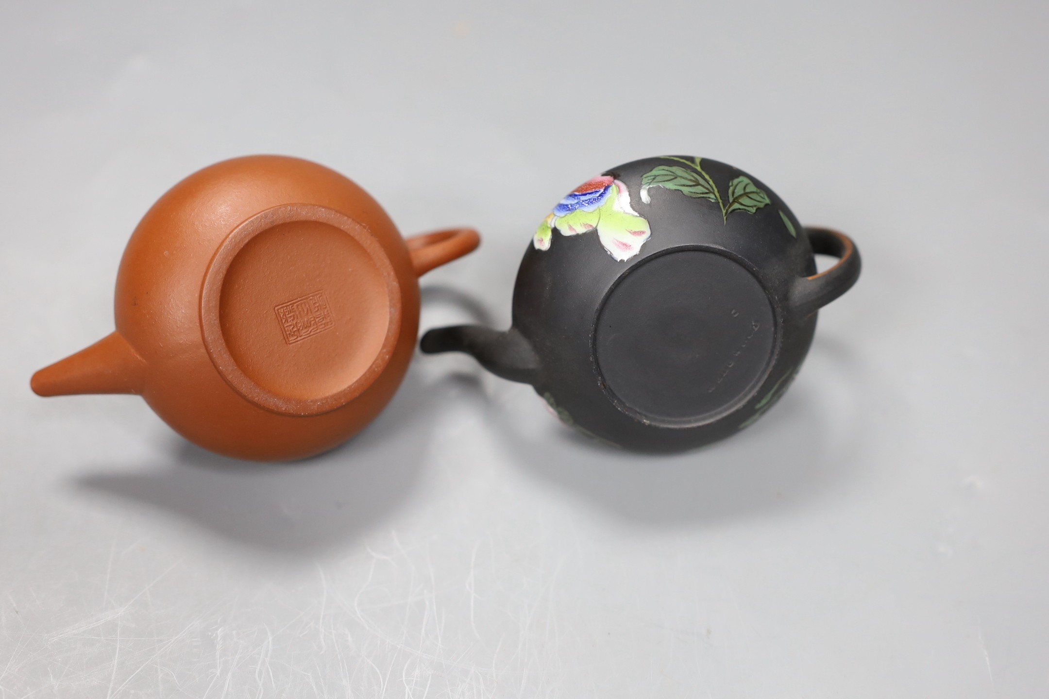 A Chinese Yixing miniature teapot and a Wedgwood enamelled black basalt miniature teapot, 6cm high